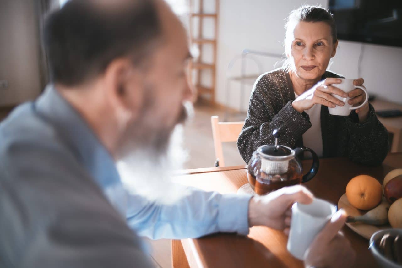 Middle-aged couple enjoying breakfast together.