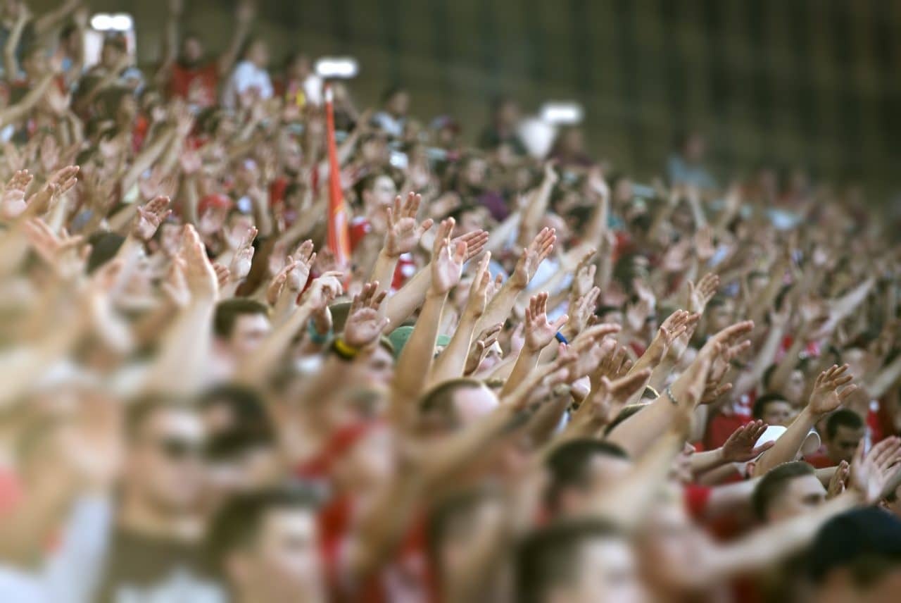 Crowd clapping on the podium of the stadium